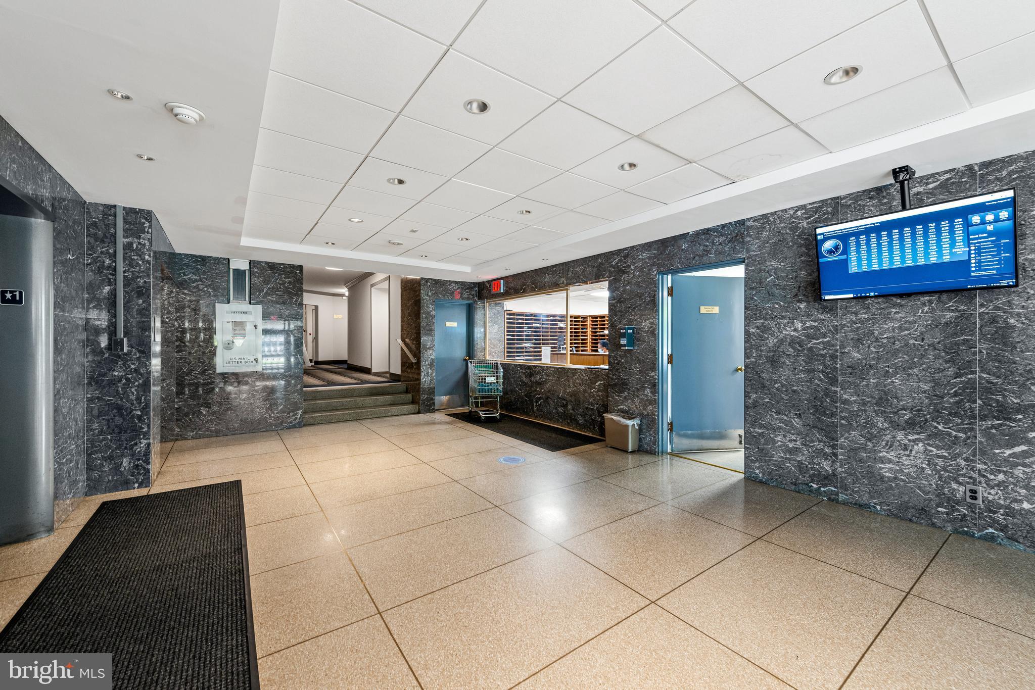 2475 Virginia Avenue Northwest, Unit 700 Washington, DC 20037 - Photo 31 of 36 a lobby with furniture and a refrigerator