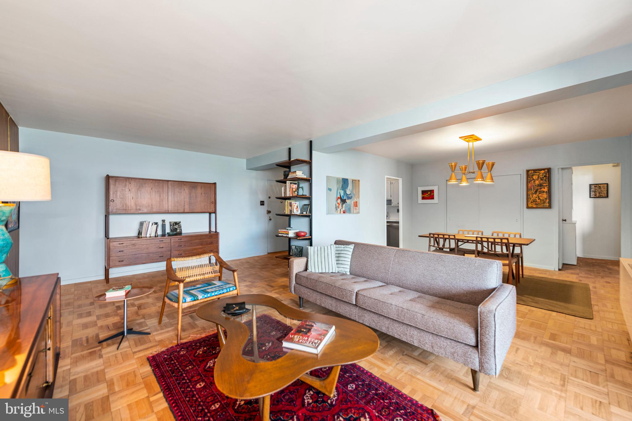 2475 Virginia Avenue Northwest, Unit 700 Washington, DC 20037 - Photo 5 of 36 a living room with furniture and a flat screen tv