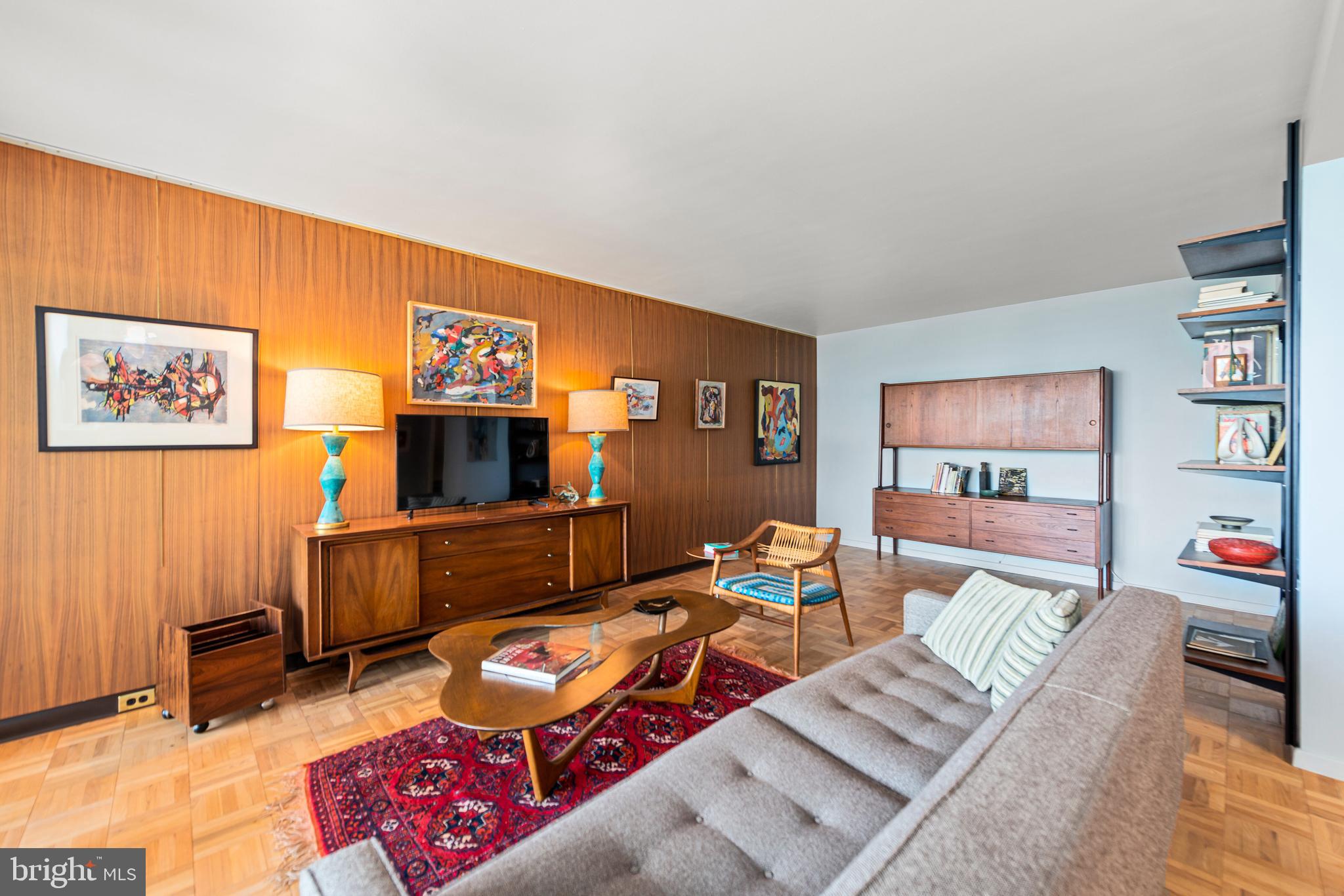 2475 Virginia Avenue Northwest, Unit 700 Washington, DC 20037 - Photo 7 of 36 a living room with furniture and a flat screen tv