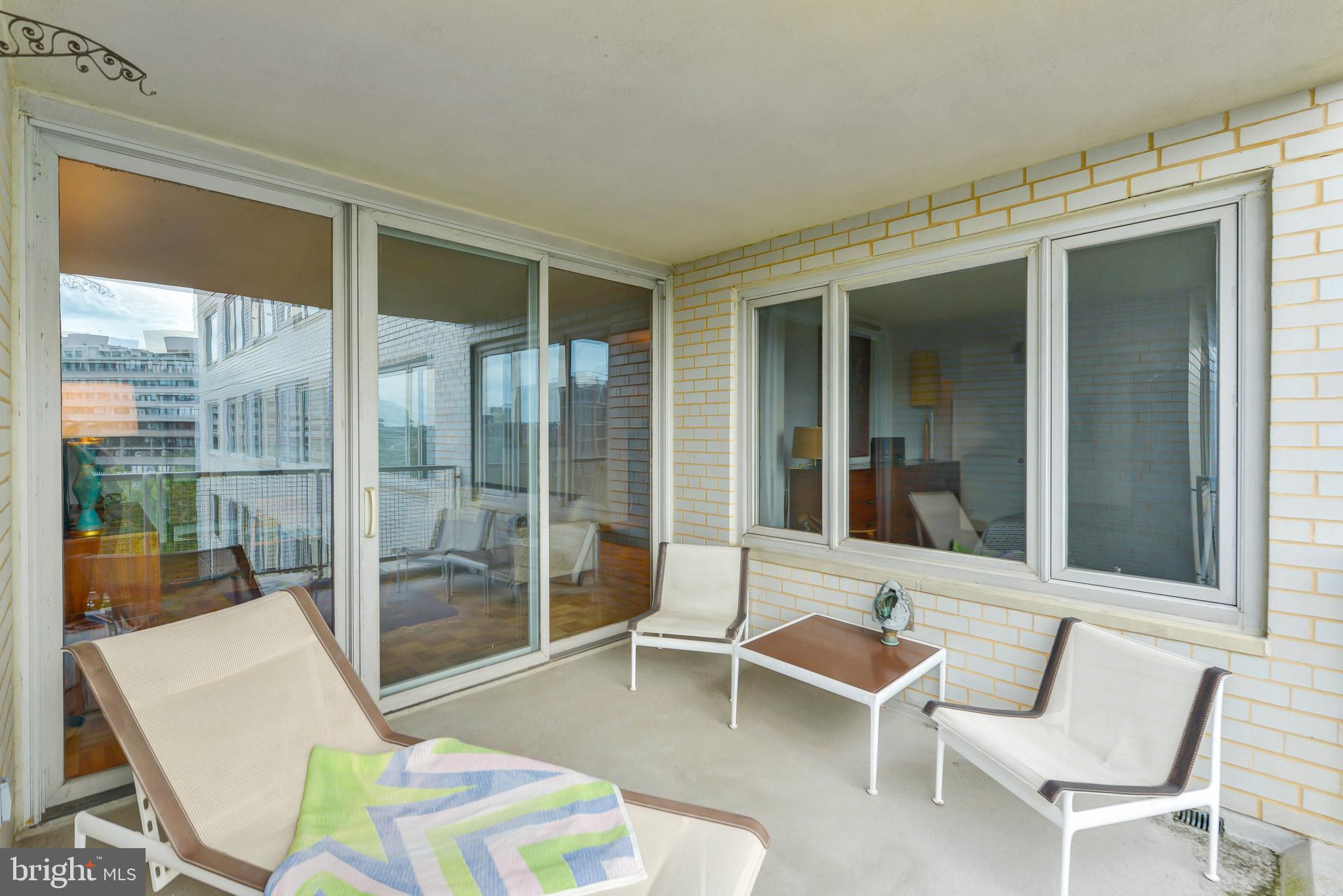 2475 Virginia Avenue Northwest, Unit 700 Washington, DC 20037 - Photo 8 of 36 a balcony with table and chairs
