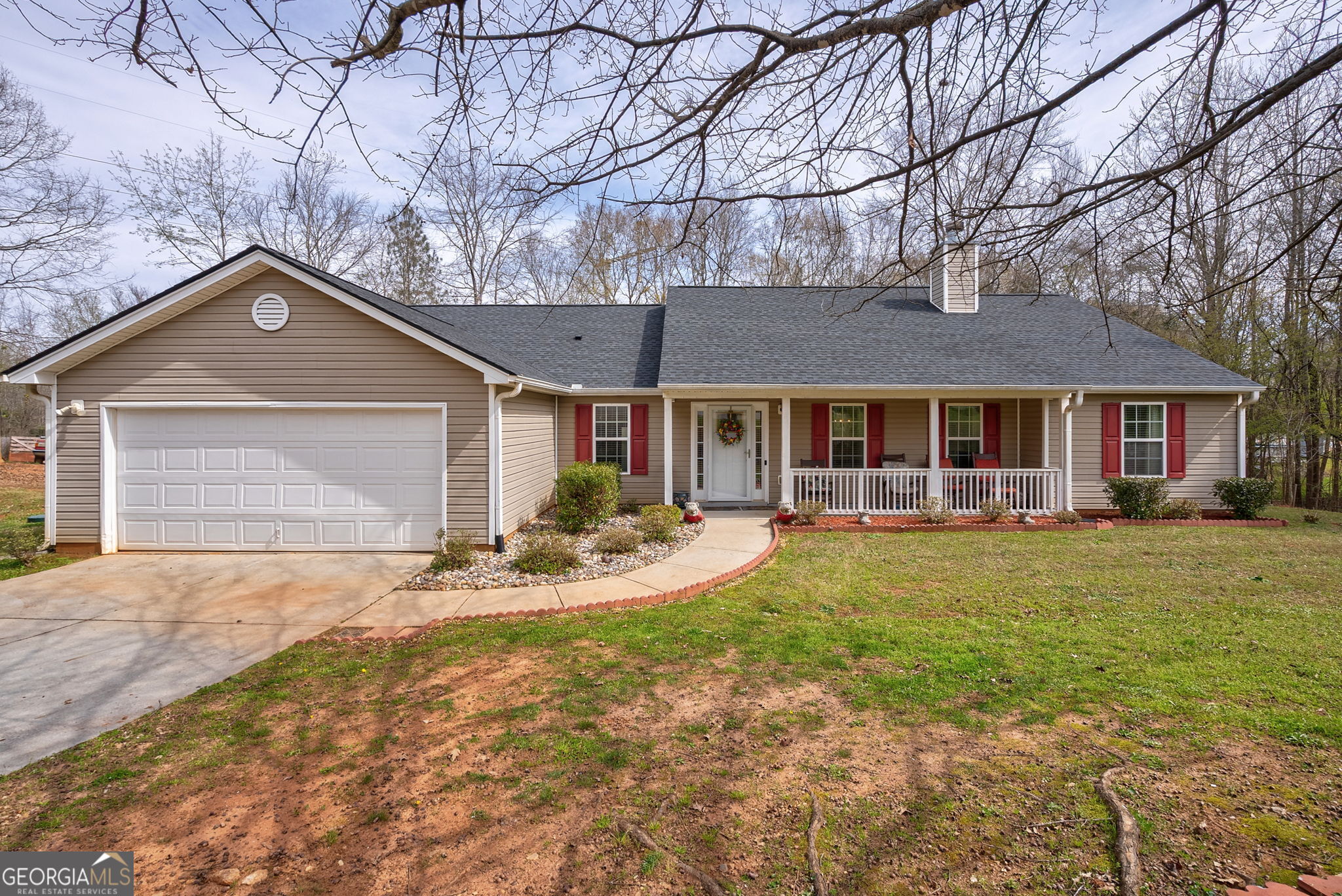 1415 Blanding Way Winder, GA 30680 - Photo 1 of 39 a front view of a house with a garden and trees