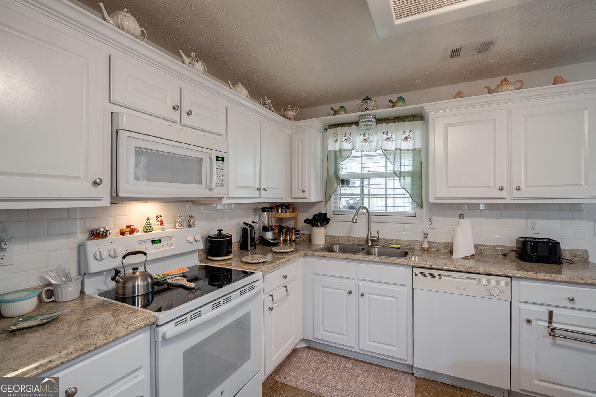 1415 Blanding Way Winder, GA 30680 - Photo 3 of 39 a kitchen with cabinets appliances a sink and a window