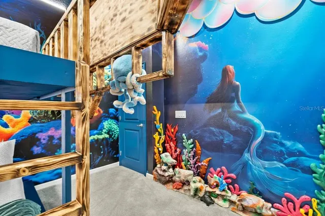 a dining room with glass top table and chairs