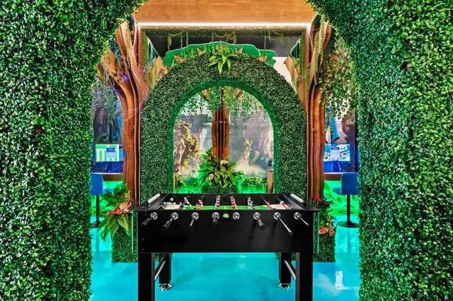 a view of a living room with a table and chairs