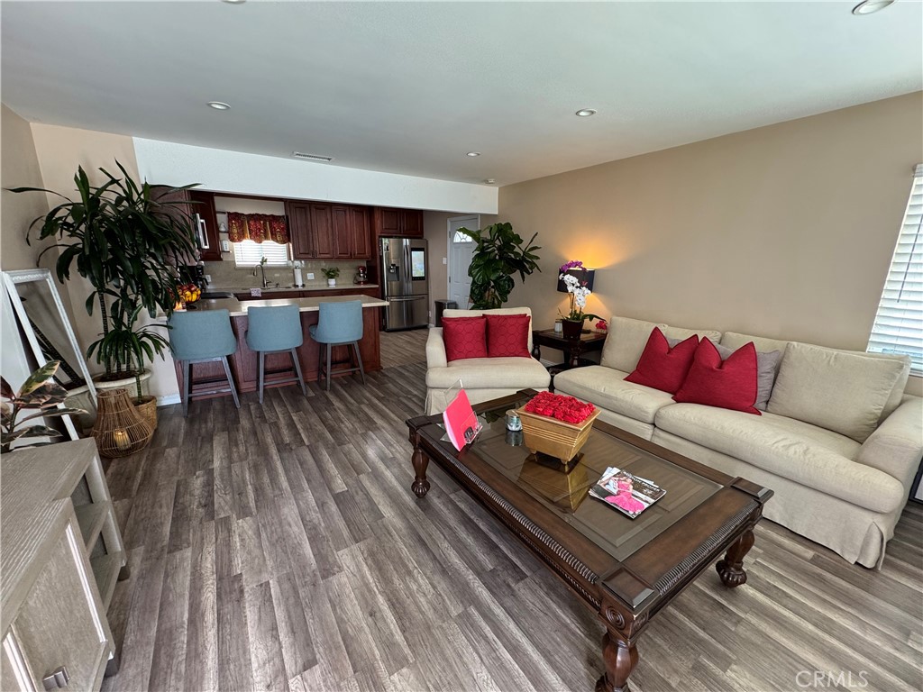 15057 Paddock Street Sylmar, CA 91342 - Photo 15 of 19 a living room with furniture and a wooden floor
