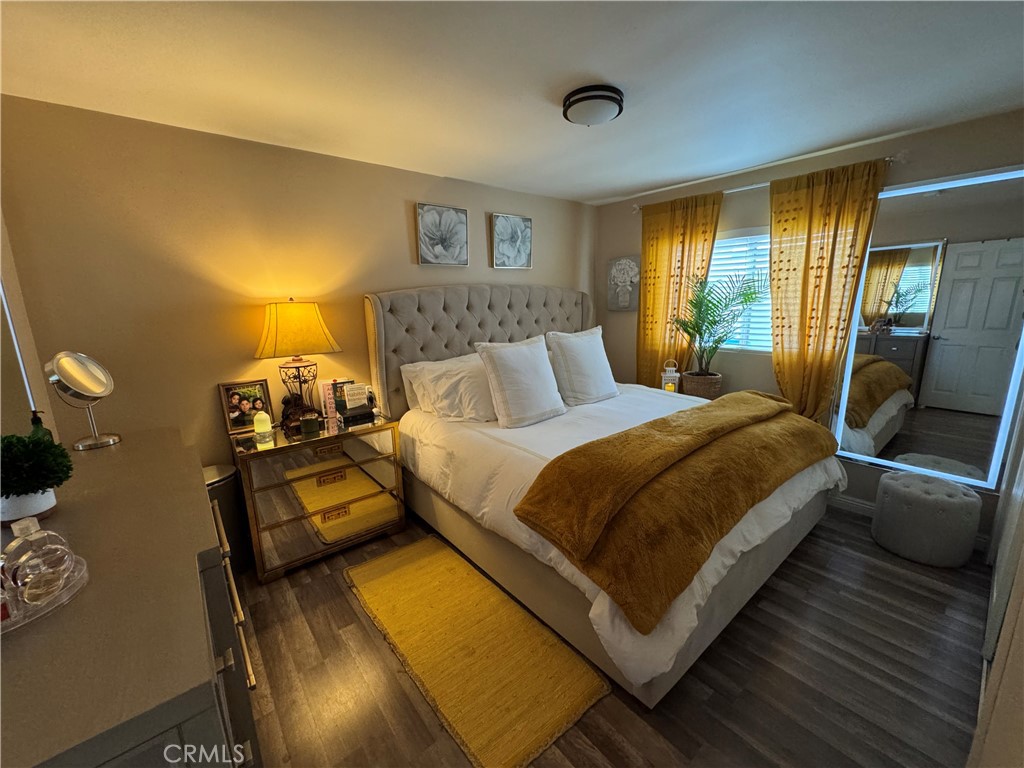 15057 Paddock Street Sylmar, CA 91342 - Photo 17 of 19 a bedroom with a bed and wooden floor