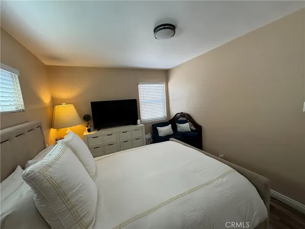 a bedroom with a large bed and a window