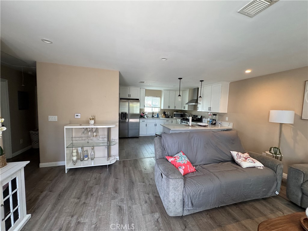 15057 Paddock Street Sylmar, CA 91342 - Photo 3 of 19 a living room with furniture and a wooden floor