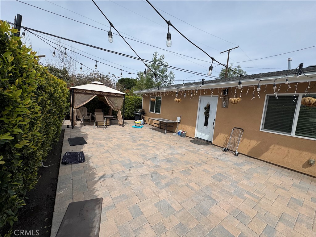 15057 Paddock Street Sylmar, CA 91342 - Photo 7 of 19 a view of a patio with a table and chairs