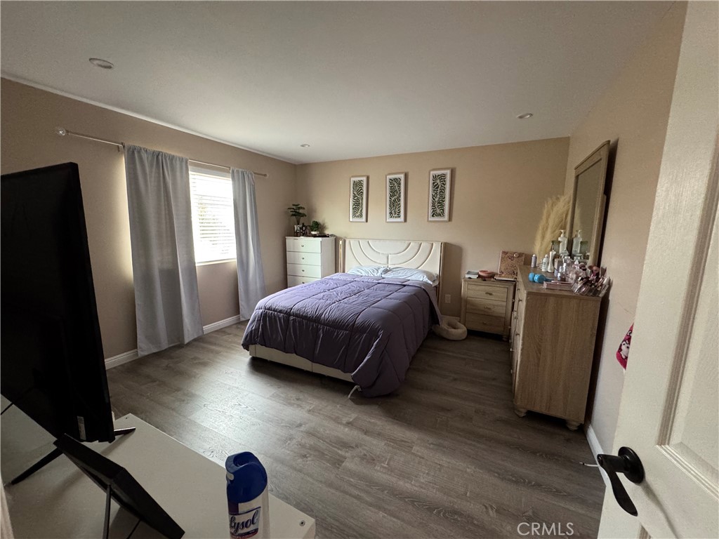 15057 Paddock Street Sylmar, CA 91342 - Photo 9 of 19 a bedroom with a bed and a mirror