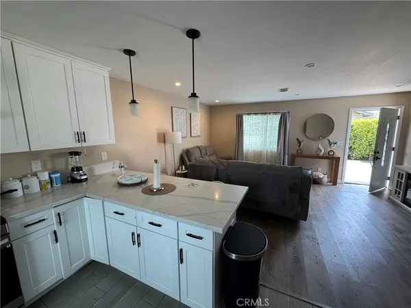a view of a livingroom with furniture and a flat screen tv