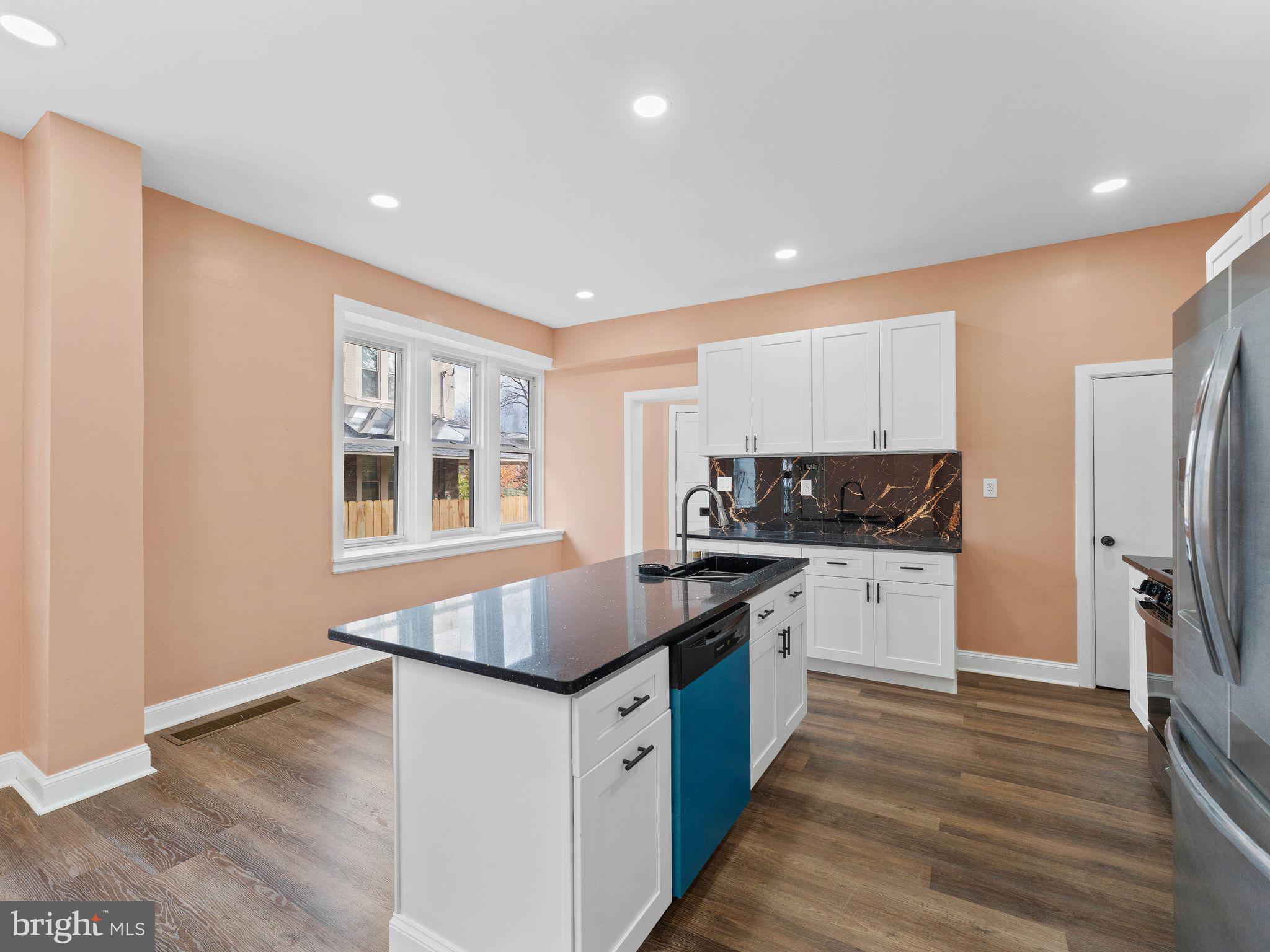 413 High Street Philadelphia, PA 19144 - Photo 13 of 37 a kitchen with stainless steel appliances granite countertop a stove a sink and a refrigerator