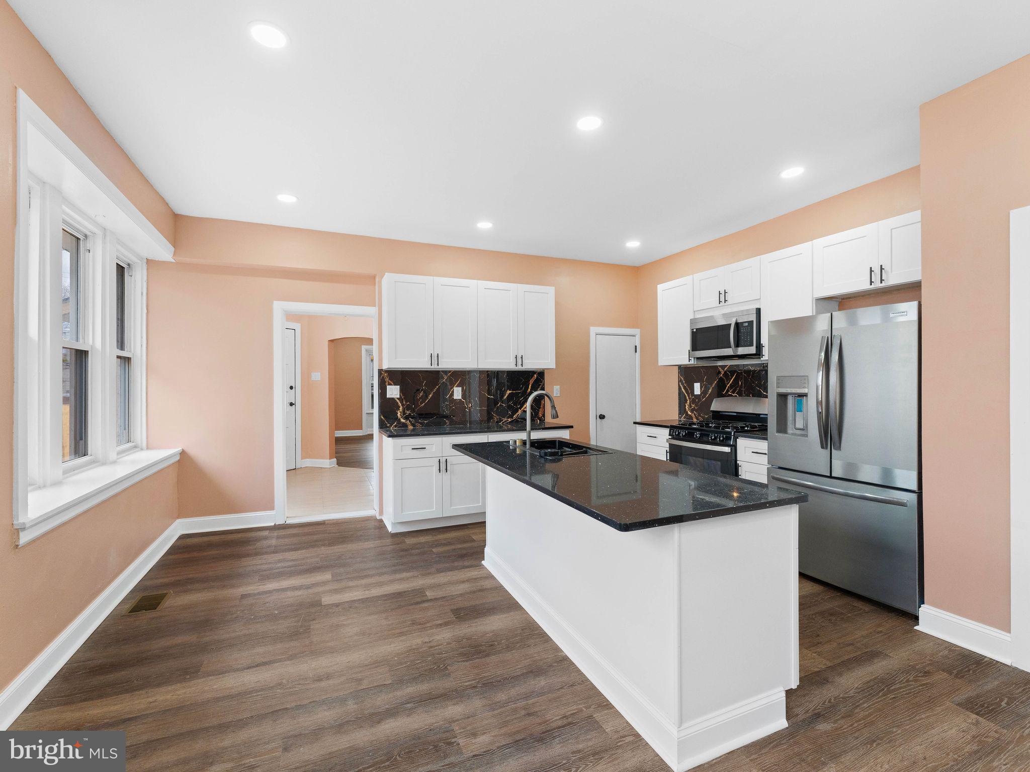 413 High Street Philadelphia, PA 19144 - Photo 14 of 37 a kitchen with stainless steel appliances kitchen island granite countertop a refrigerator and a sink