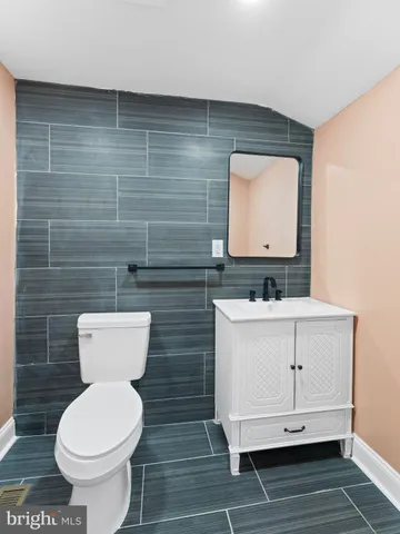 a view of empty room with wooden floor and fireplace