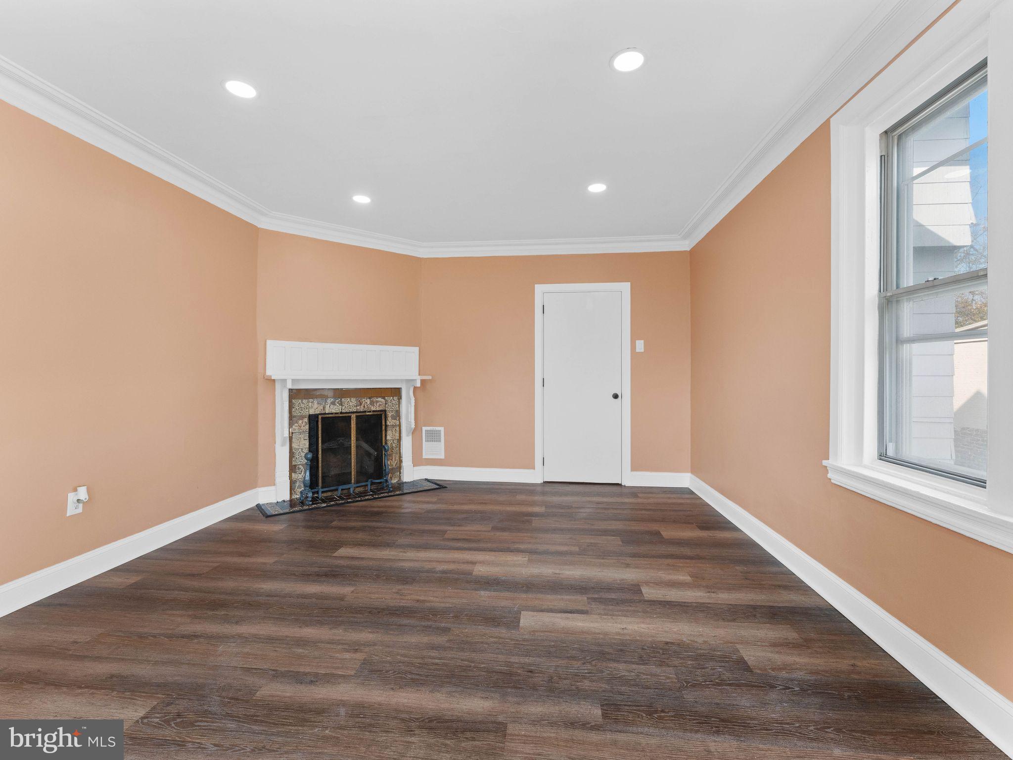 413 High Street Philadelphia, PA 19144 - Photo 21 of 37 a view of empty room with wooden floor and fireplace