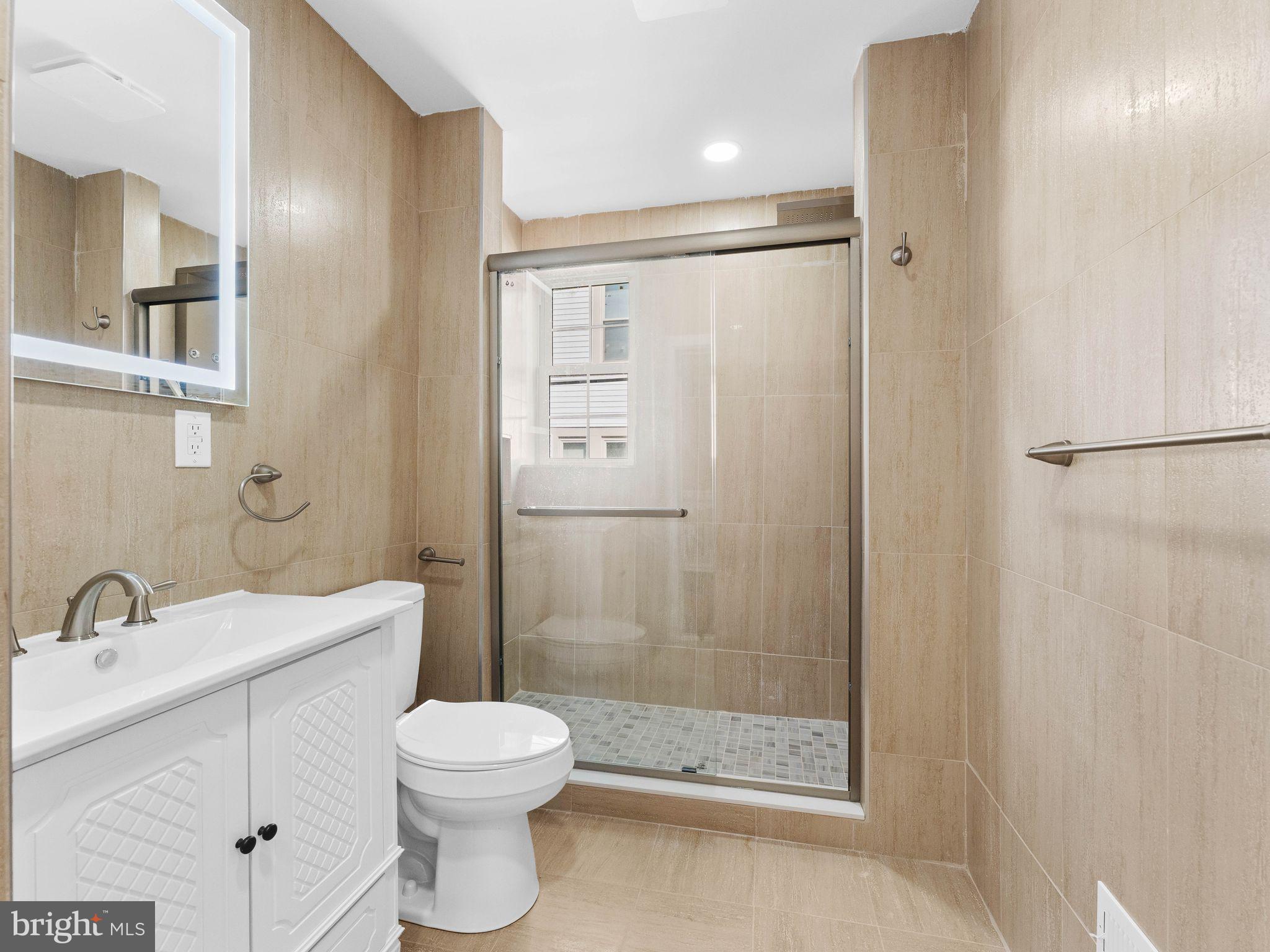 413 High Street Philadelphia, PA 19144 - Photo 25 of 37 a bathroom with a shower a sink and a toilet