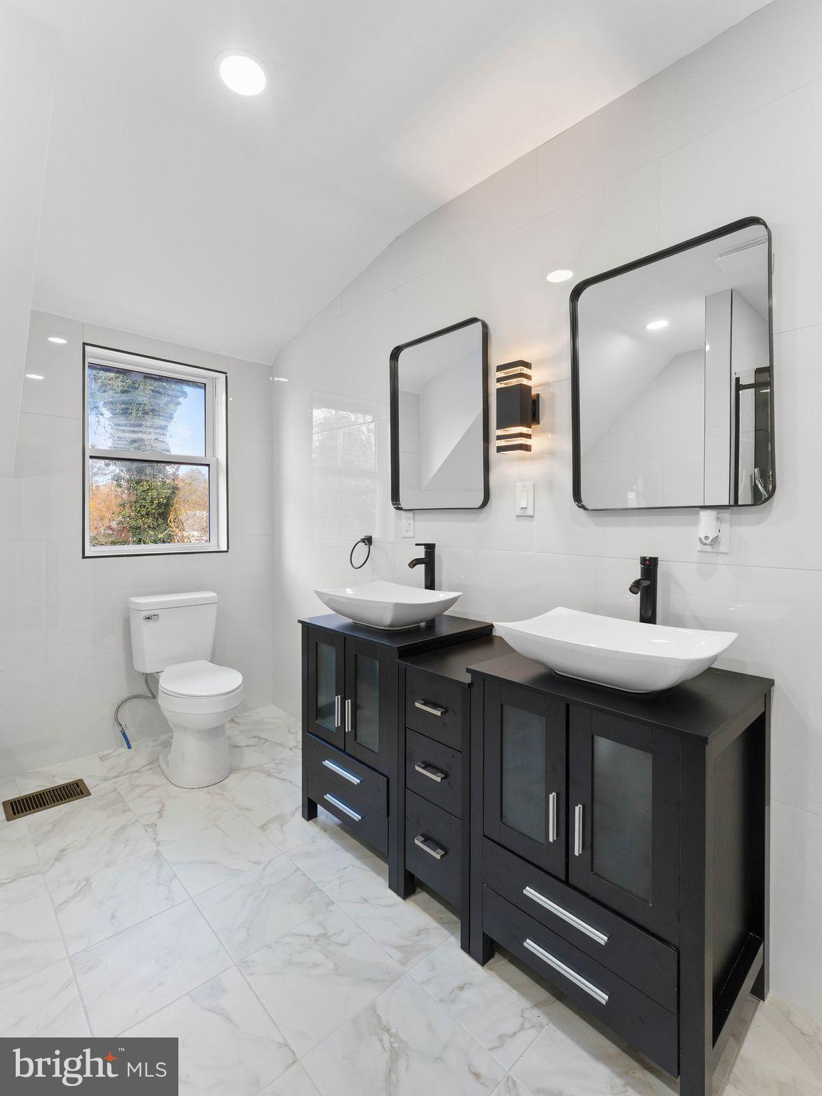 413 High Street Philadelphia, PA 19144 - Photo 31 of 37 a bathroom with a double vanity sink and a mirror