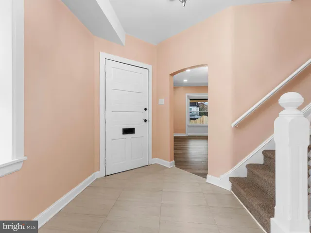 a view of an empty room with a window and fireplace