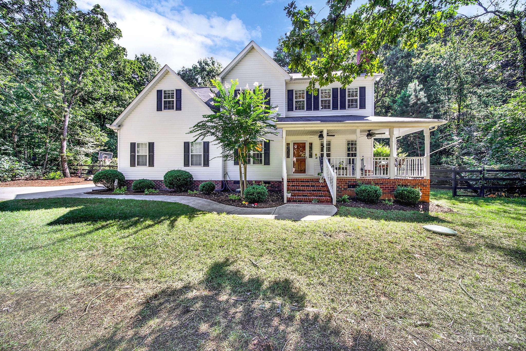 a front view of a house with a yard table and chairs
