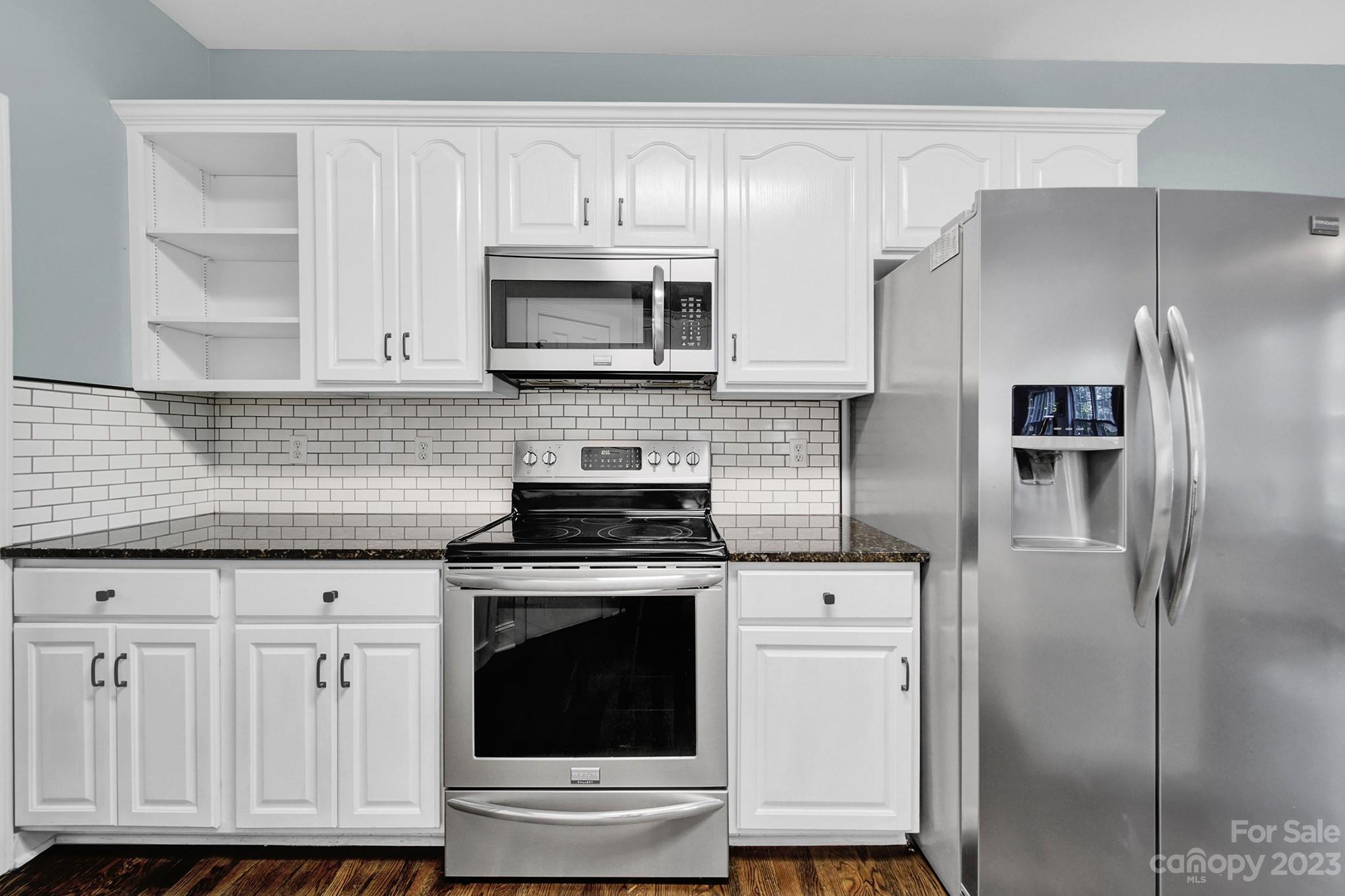 16014 Virginia Lee Court Fort Mill, SC 29708 - Photo 13 of 47 a kitchen with cabinets stainless steel appliances and wooden floor