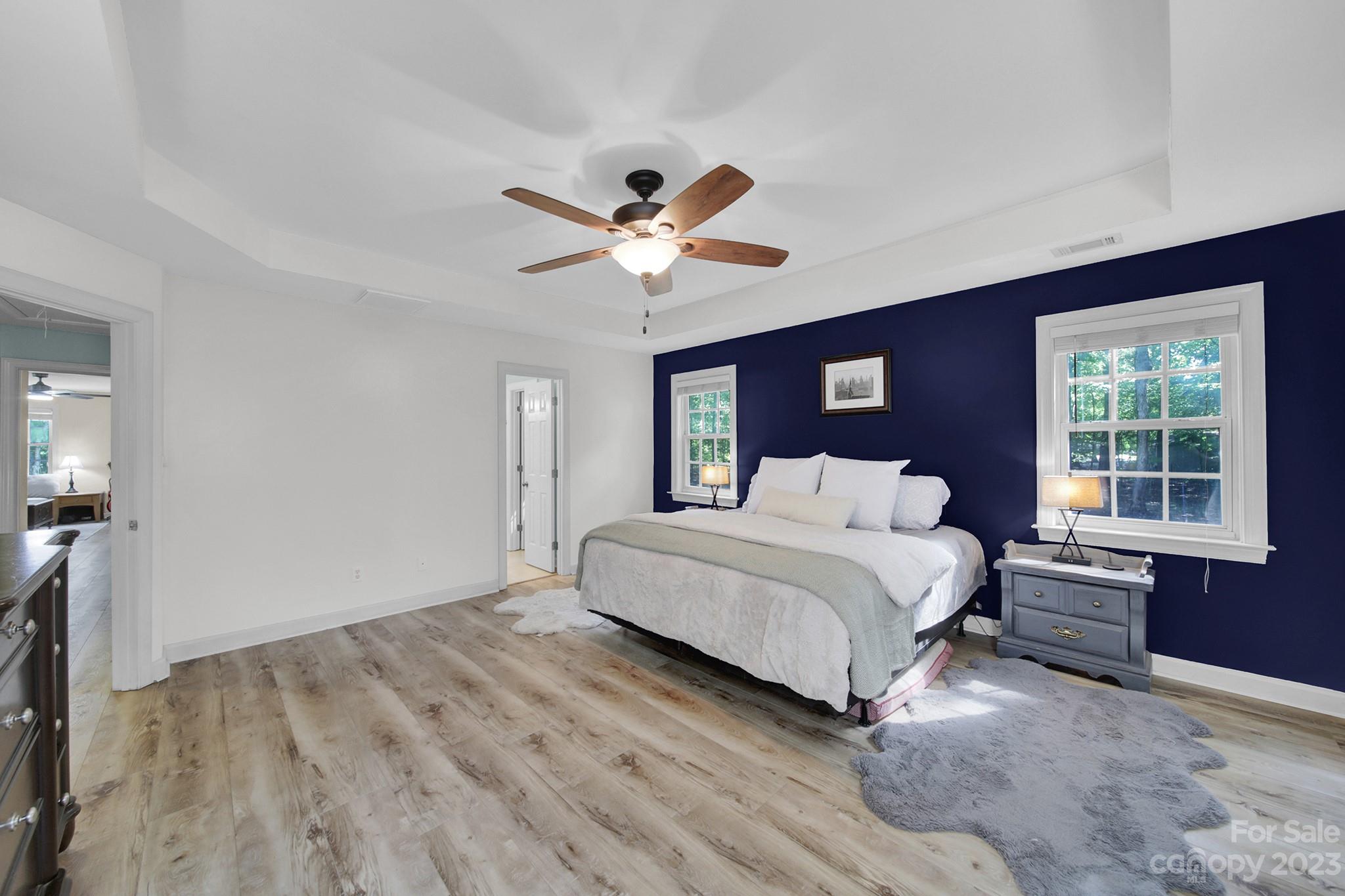16014 Virginia Lee Court Fort Mill, SC 29708 - Photo 21 of 47 a spacious bedroom with a bed and a chandelier