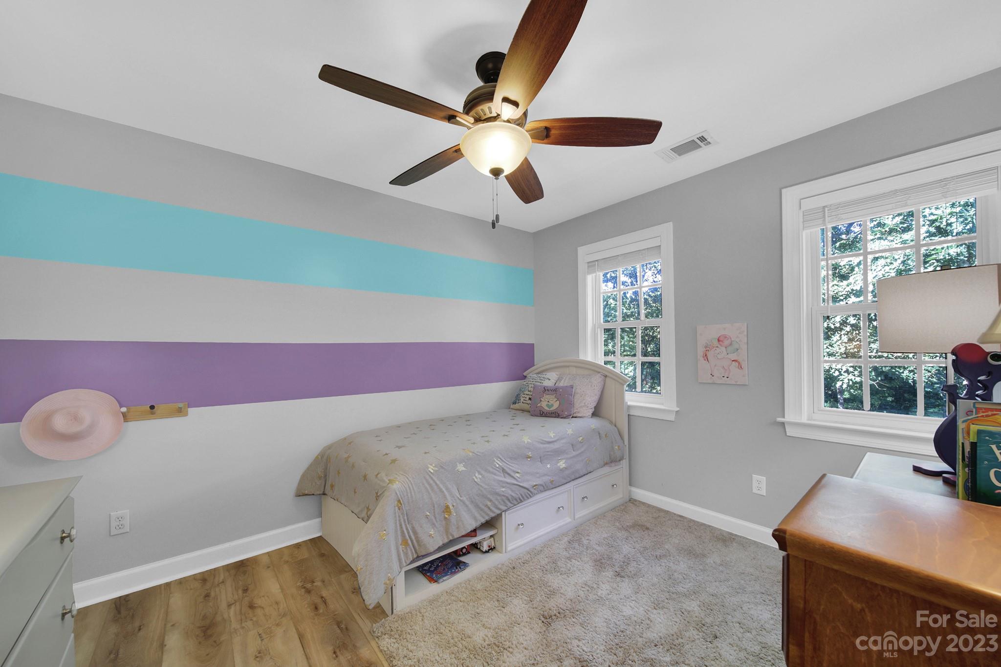 16014 Virginia Lee Court Fort Mill, SC 29708 - Photo 27 of 47 a bedroom with a bed and a chandelier