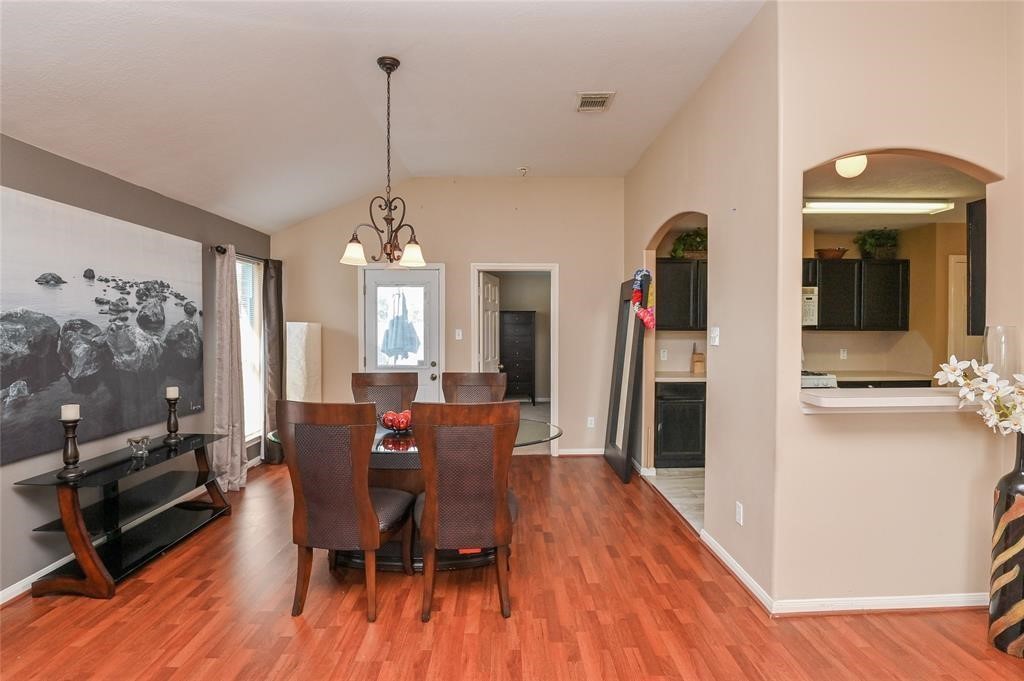 18446 South Wimbledon Drive Katy, TX 77449 - Photo 11 of 24 a view of a dining room with furniture window and wooden floor