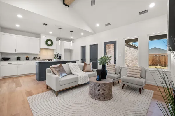 a living room with furniture and a large window