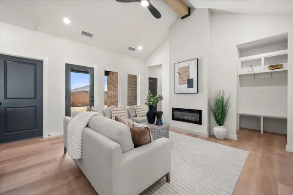 a living room with furniture a fireplace and a wooden floor