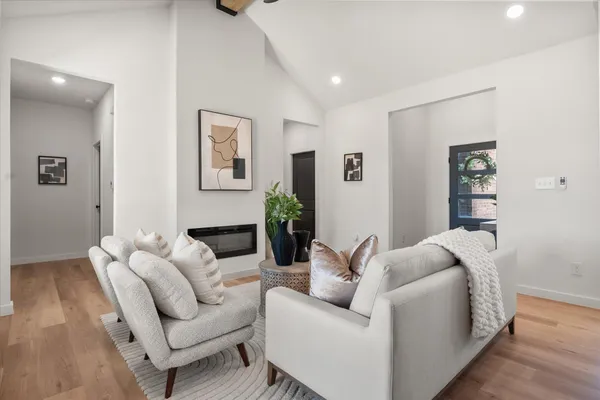 a living room with furniture and a wooden floor