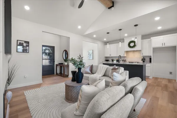 a living room with furniture and a wooden floor