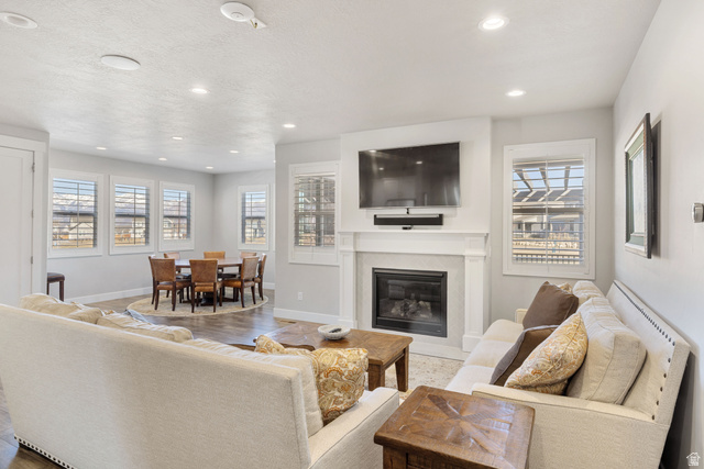 2745 Red Barn Road South Heber City, UT 84032 - Photo 2 of 51 Living area with a glass covered fireplace, recessed lighting, healthy amount of natural light, and wood finished floors