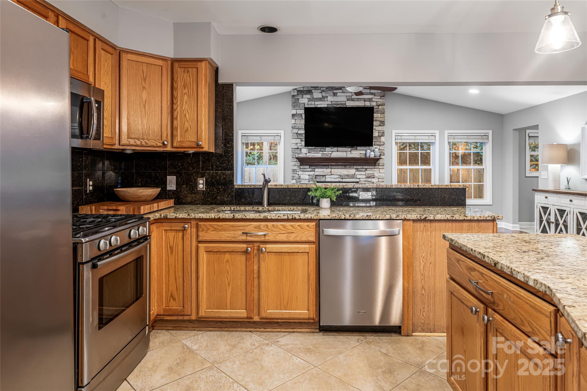 315 Glenn Bridge Road Arden, NC 28704 - Photo 16 of 45 a kitchen with stainless steel appliances granite countertop a stove a sink and a microwave