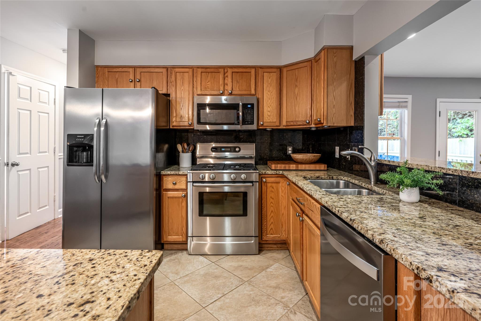 315 Glenn Bridge Road Arden, NC 28704 - Photo 19 of 45 a kitchen with kitchen island granite countertop a sink stove and refrigerator