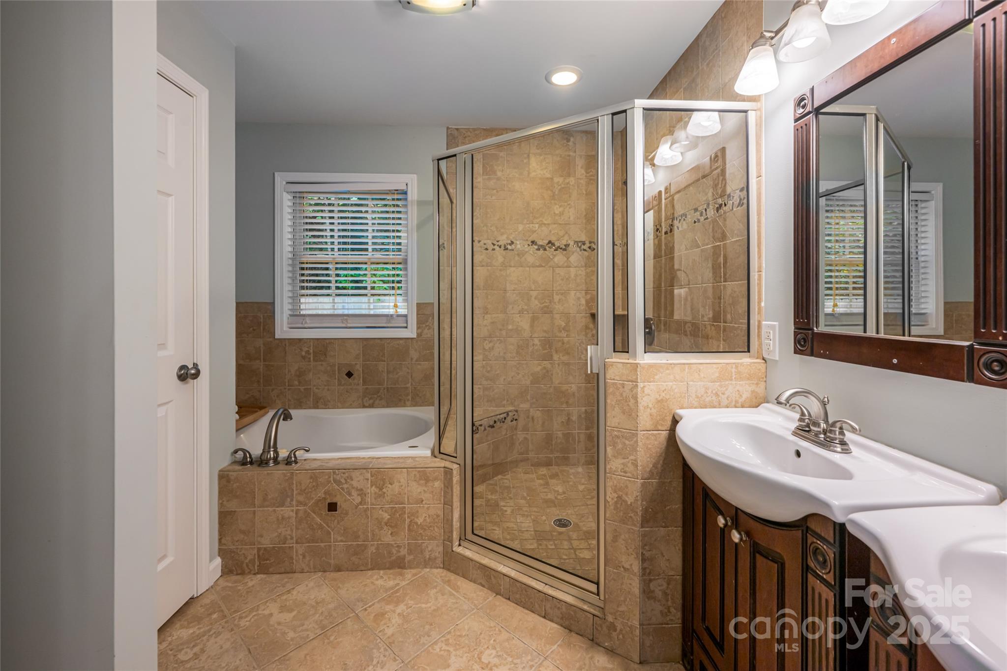 315 Glenn Bridge Road Arden, NC 28704 - Photo 28 of 45 a bathroom with a tub sink and mirror