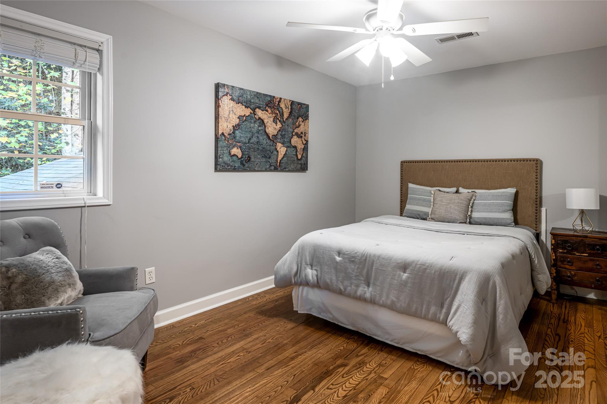 315 Glenn Bridge Road Arden, NC 28704 - Photo 31 of 45 a bedroom with a bed and wooden floor