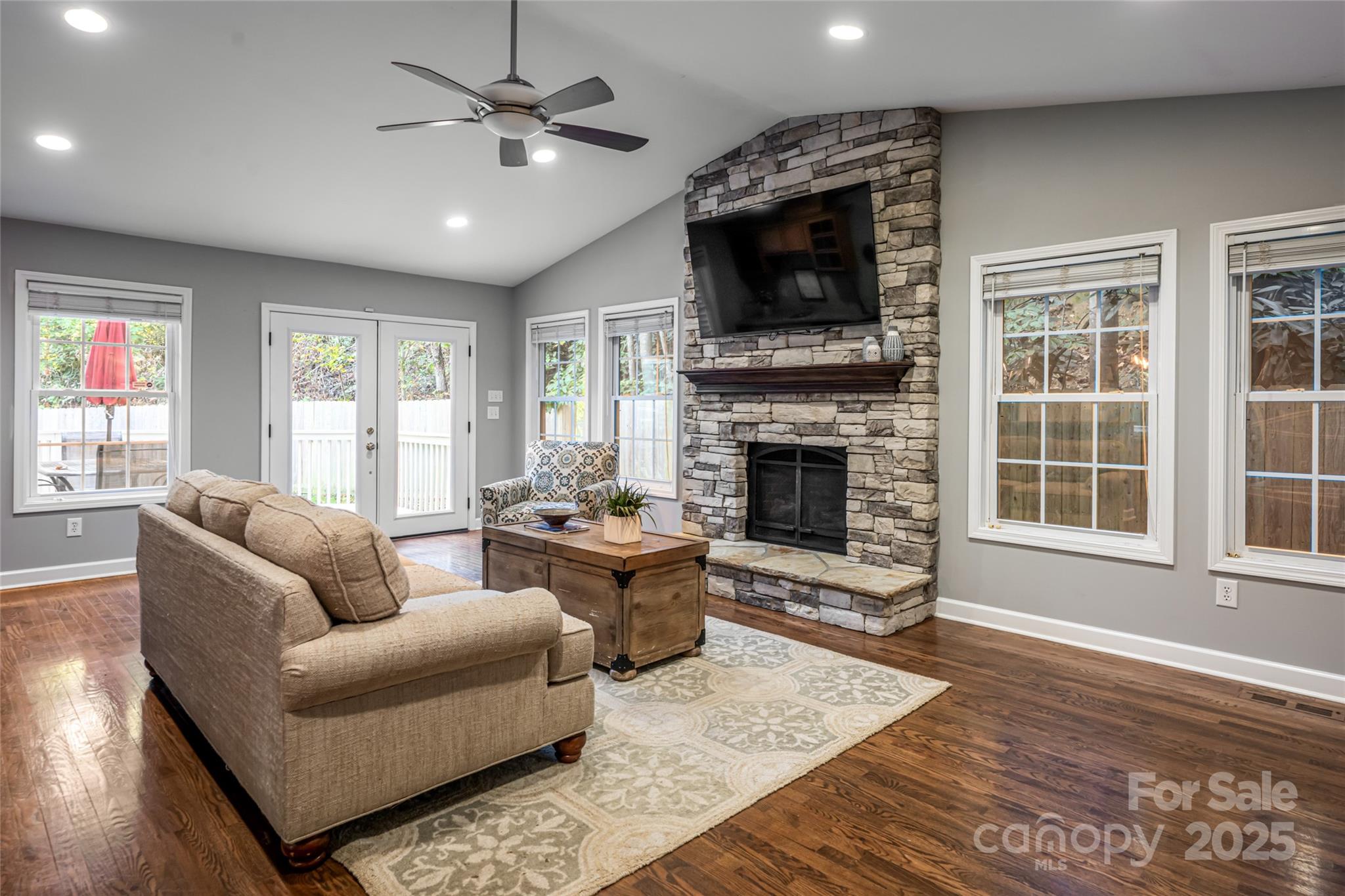 315 Glenn Bridge Road Arden, NC 28704 - Photo 8 of 45 a living room with furniture a fireplace and a flat screen tv