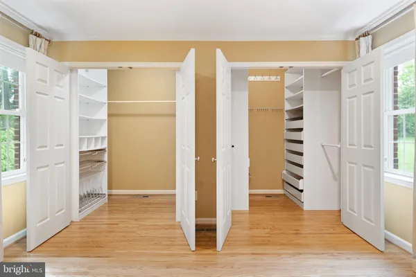 a view of wooden floor and windows in a room