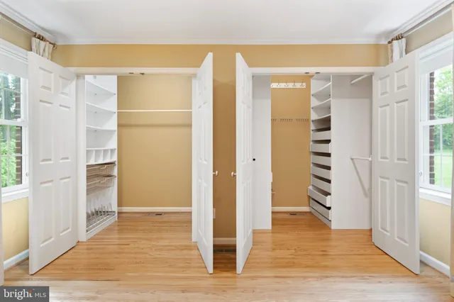 a view of wooden floor and windows in a room