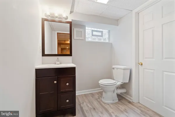 a bathroom with a toilet sink and mirror