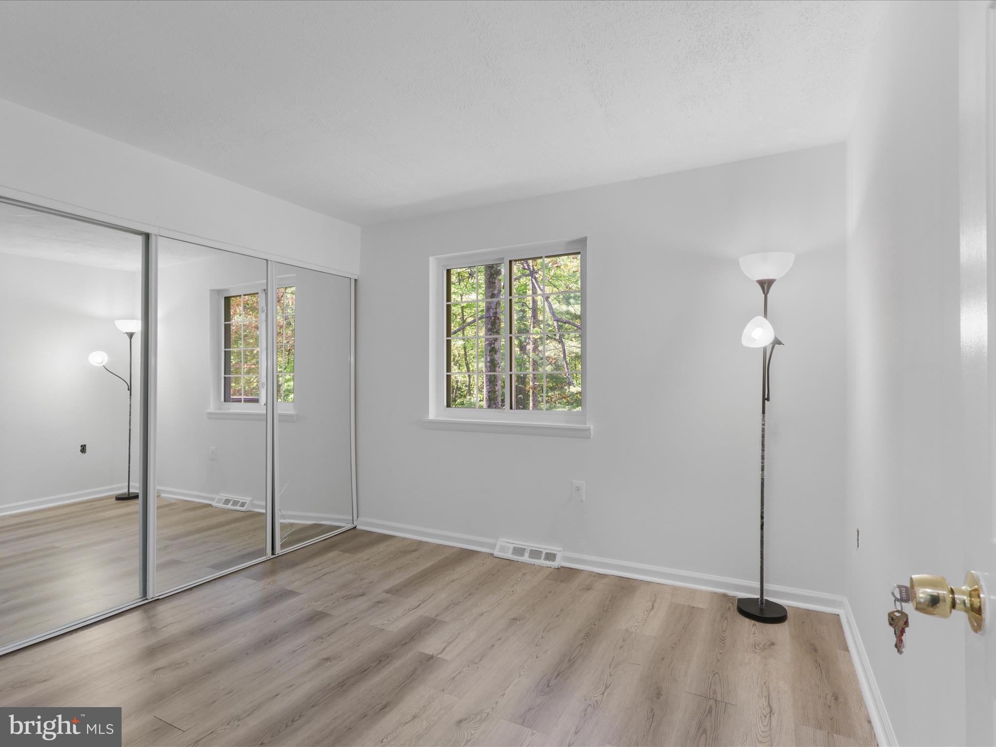 2369 Old Trail Drive Reston, VA 20191 - Photo 20 of 50 a view of an empty room with window and wooden floor