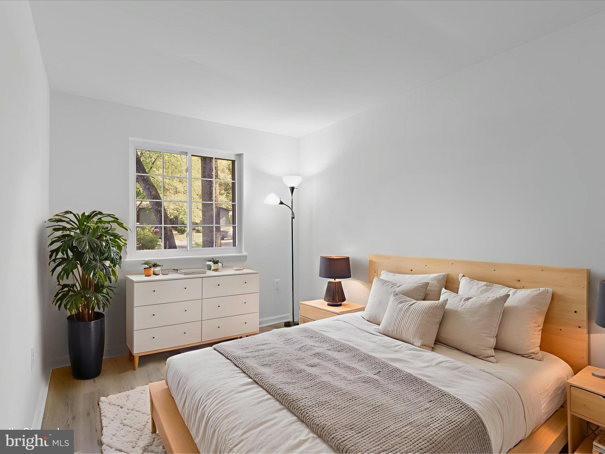 2369 Old Trail Drive Reston, VA 20191 - Photo 23 of 50 a bedroom with a bed and a potted plant