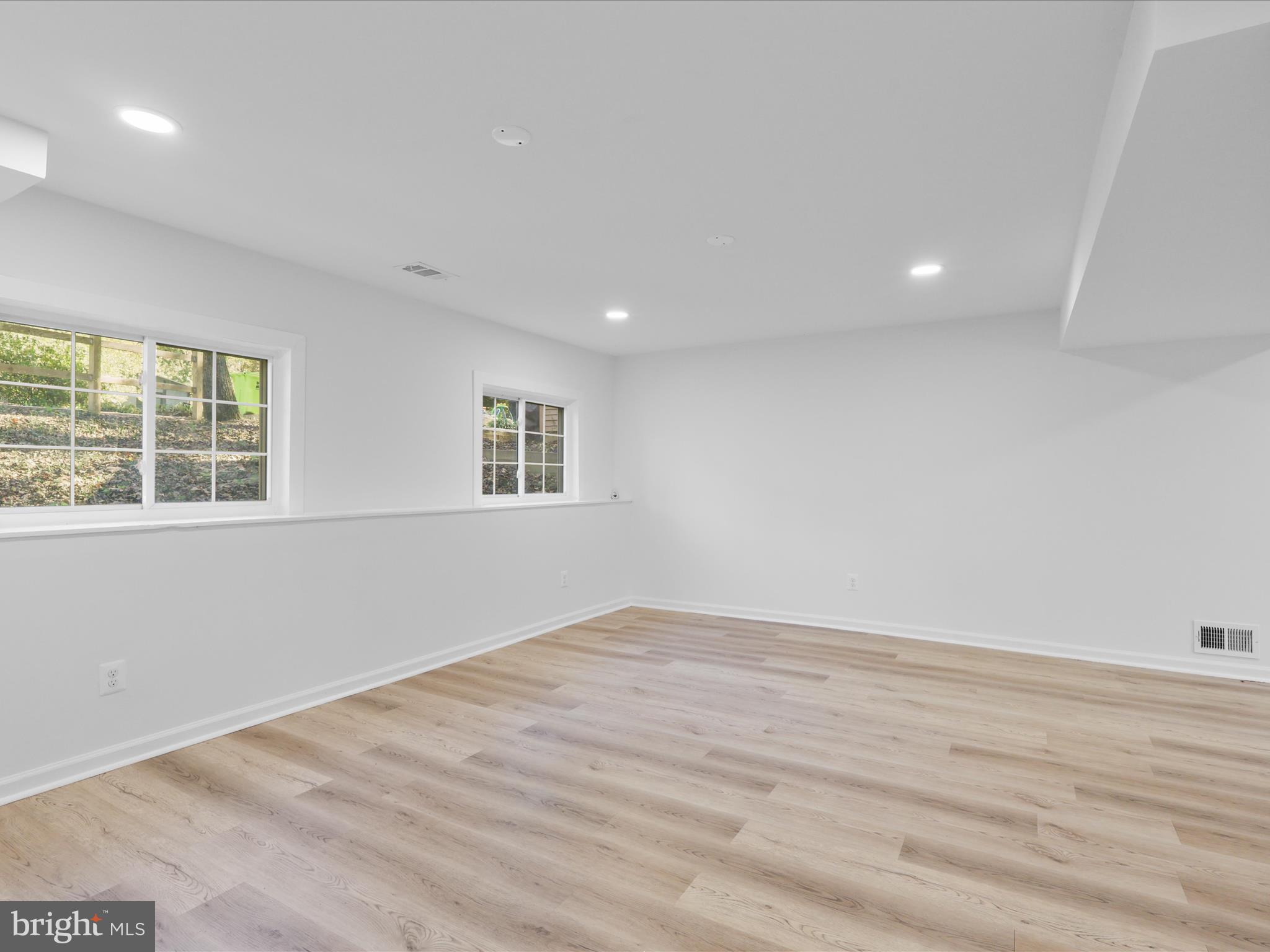 2369 Old Trail Drive Reston, VA 20191 - Photo 28 of 50 an empty room with wooden floor and windows