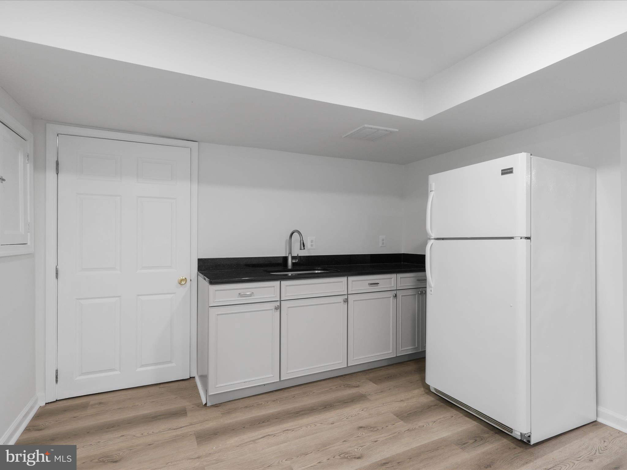 2369 Old Trail Drive Reston, VA 20191 - Photo 33 of 50 a kitchen with a sink and a refrigerator