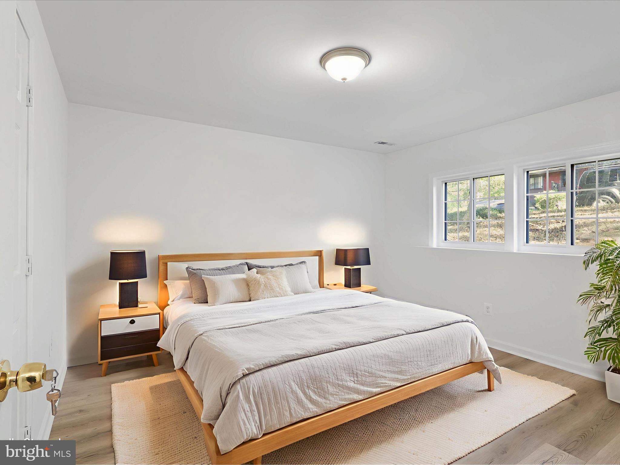 2369 Old Trail Drive Reston, VA 20191 - Photo 35 of 50 a bedroom with a bed and a night stand