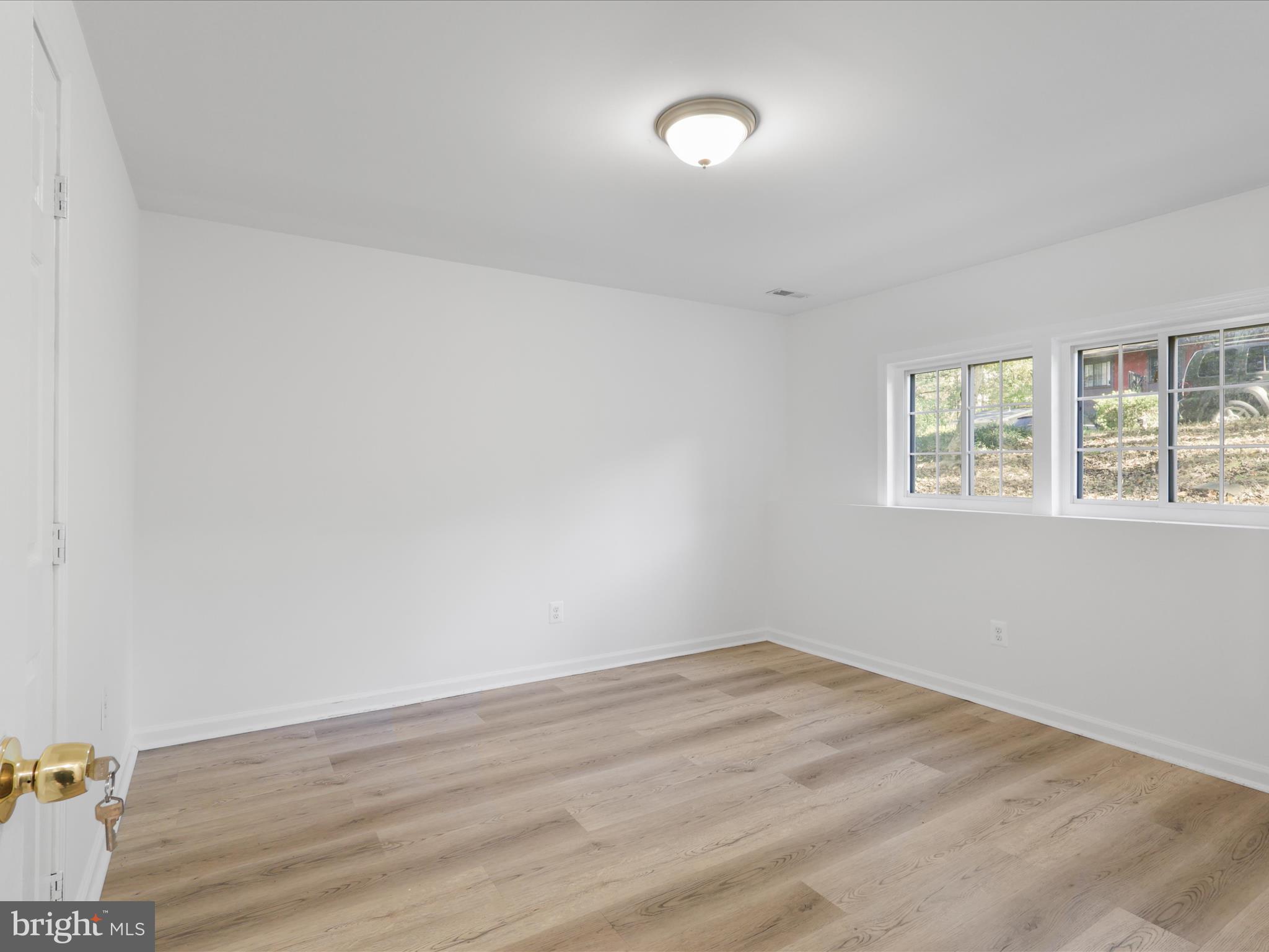 2369 Old Trail Drive Reston, VA 20191 - Photo 36 of 50 an empty room with wooden floor and windows