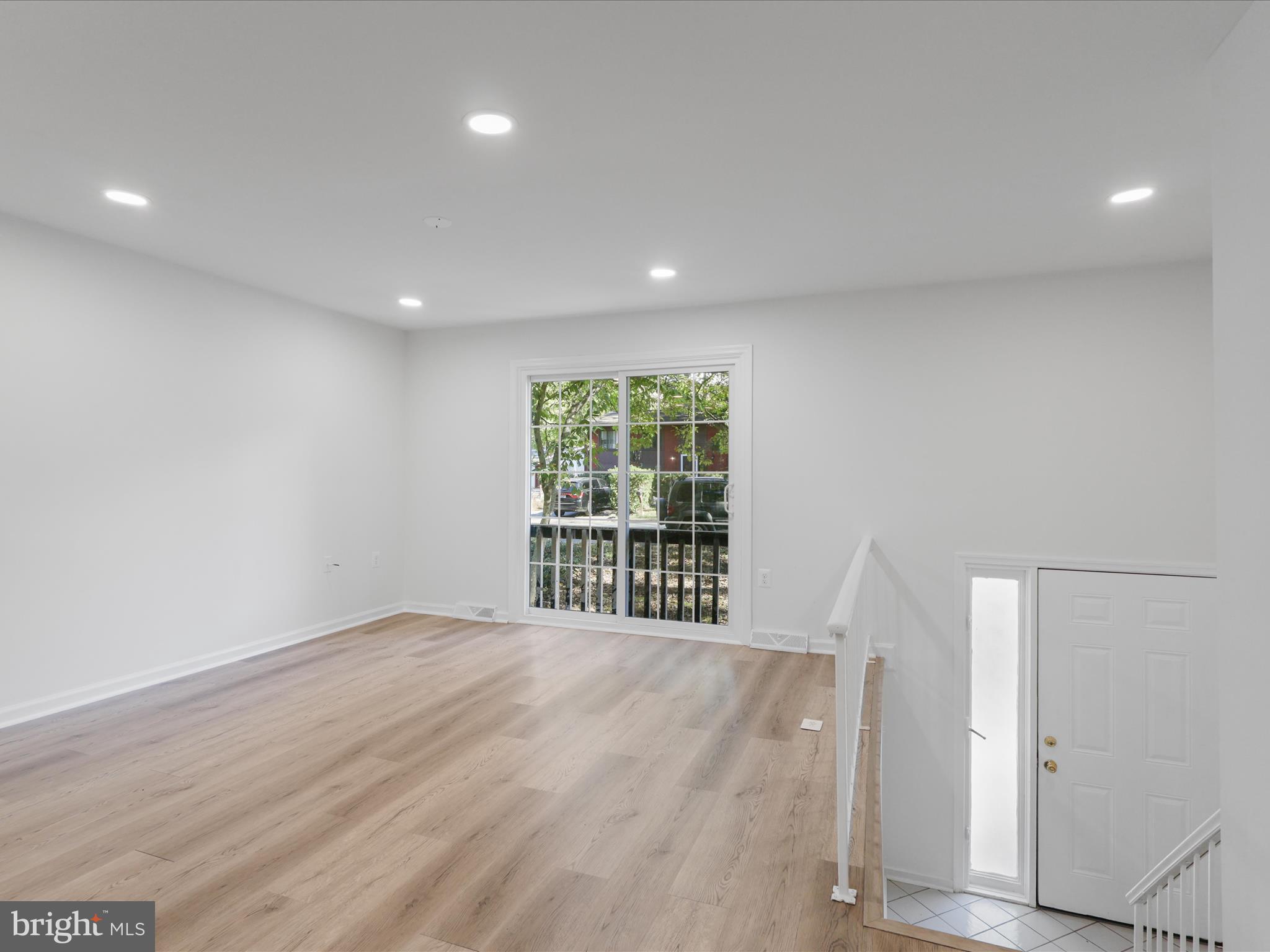 2369 Old Trail Drive Reston, VA 20191 - Photo 39 of 50 an empty room with wooden floor and windows