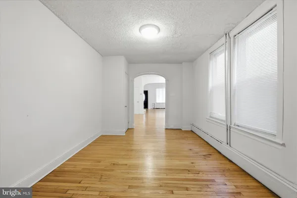 a view of a room with wooden floor