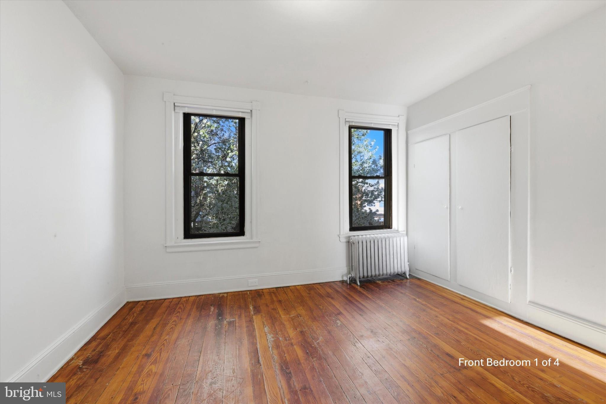 1925 South 21st Street Philadelphia, PA 19145 - Photo 8 of 15 an empty room with wooden floor and windows