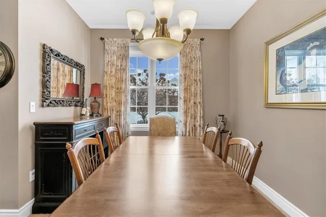 a view of a dining room with furniture and chandelier